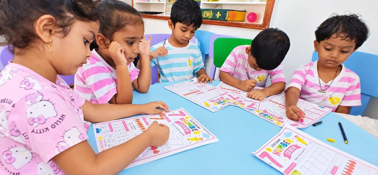 Kinderbee preschoolers tracing numbers on activity worksheets